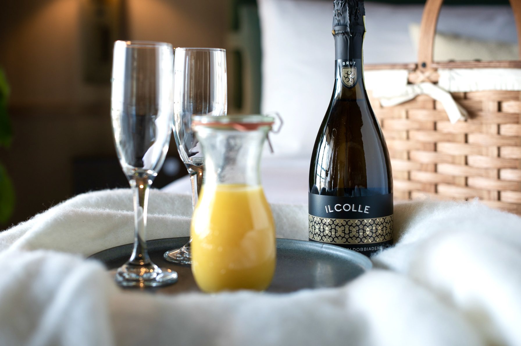 Daily breakfast basket with mimosas in bed.